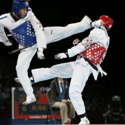 Turkey's Servet Tazegul (L) kicks Britain's Martin Stamper during their men's -68kg semifinal taekwondo match at the ExCel venue during the London Olympic Games, August 9, 2012. REUTERS/Kim Kyung-Hoon